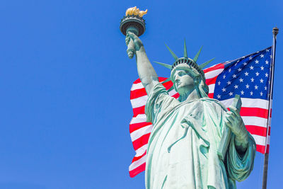 Low angle view of statue against blue sky