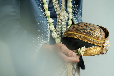 Midsection of woman holding umbrella