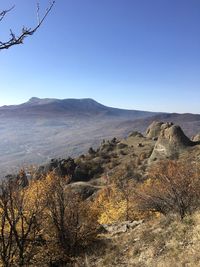 Scenic view of mountains against clear blue sky