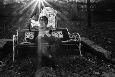 Rear view of man sitting on bench