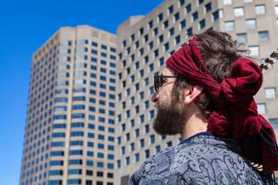 Portrait of man looking at modern office building