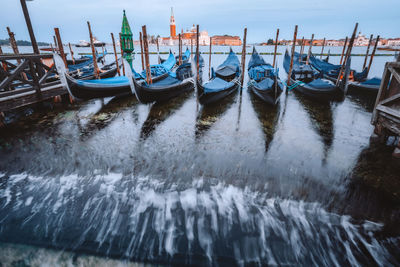 Boats moored in canal