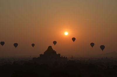 Hot air balloon in sky at sunset