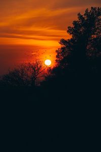 Silhouette trees on landscape against romantic sky at sunset