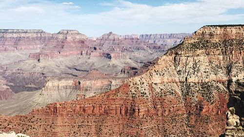 Panoramic view of rocky mountains against cloudy sky