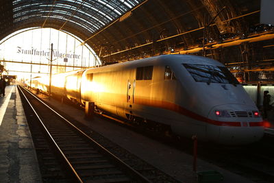 Train on railroad tracks in city against sky