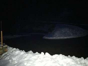 Close-up of snow against sky at night