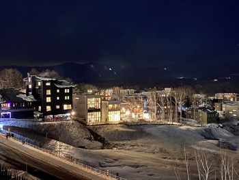 High angle view of illuminated buildings in city at night