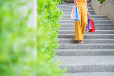 Low section of woman walking on staircase