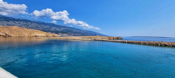 Scenic view of swimming pool by sea against sky