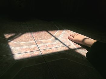 Shadow of person on tiled floor