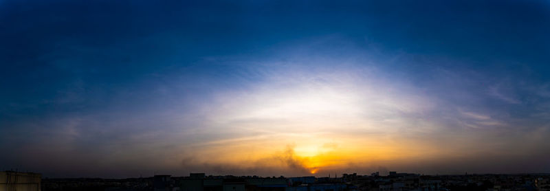 Silhouette buildings against sky during sunset