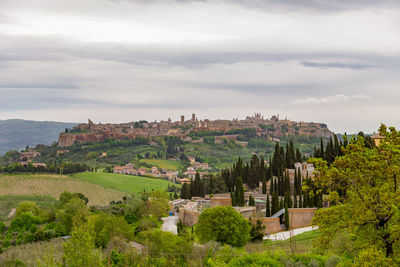 Panoramic view of trees and buildings against sky