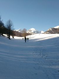 Scenic view of snow mountains against clear blue sky