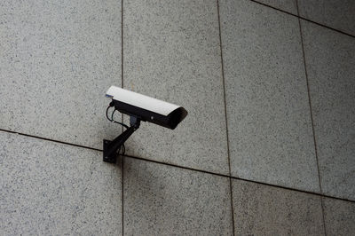 Surveillance camera mounted on a wall