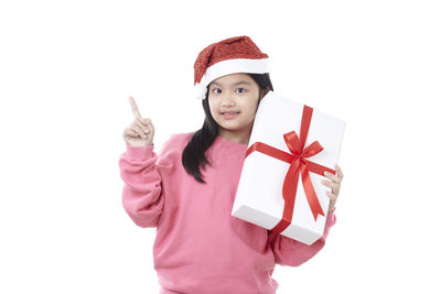 Portrait of a smiling young woman against white background