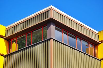 Low angle view of buildings against blue sky