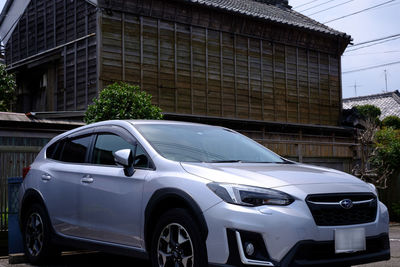 Car parked on road against buildings in city