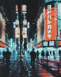 People walking on illuminated street in city at night