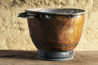 Close-up of vintage copper kettle pot in mud house 