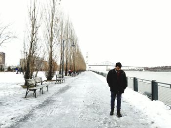Full length of man standing on snow covered landscape