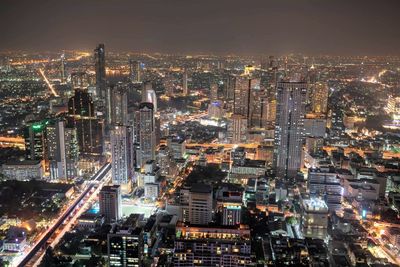 High angle view of illuminated buildings in city at night