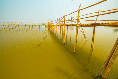 Pier over sea against clear sky