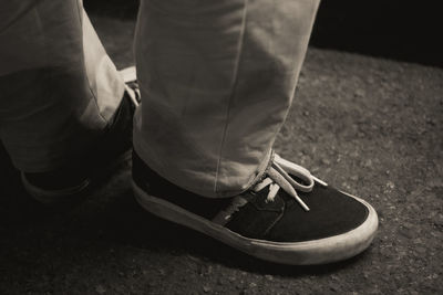 Low section of man standing on street