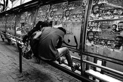 Rear view of men sitting at market