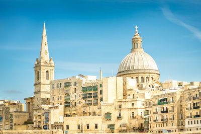 Buildings in city against sky