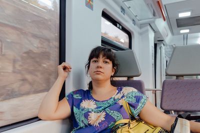 Young woman sitting on wall