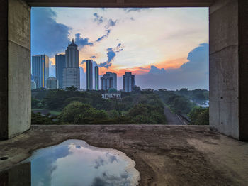 Buildings in city against cloudy sky