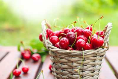 A basket with ripe fruits on a wooden table. summer harvest berries close-up. 