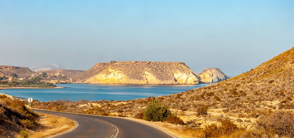 Road by mountain against sky