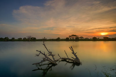 Scenic view of lake against sky during sunset