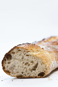 Close up of artisanal baguette on white background