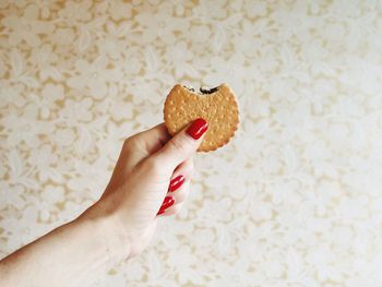 Close-up of hand holding ice cream sandwich