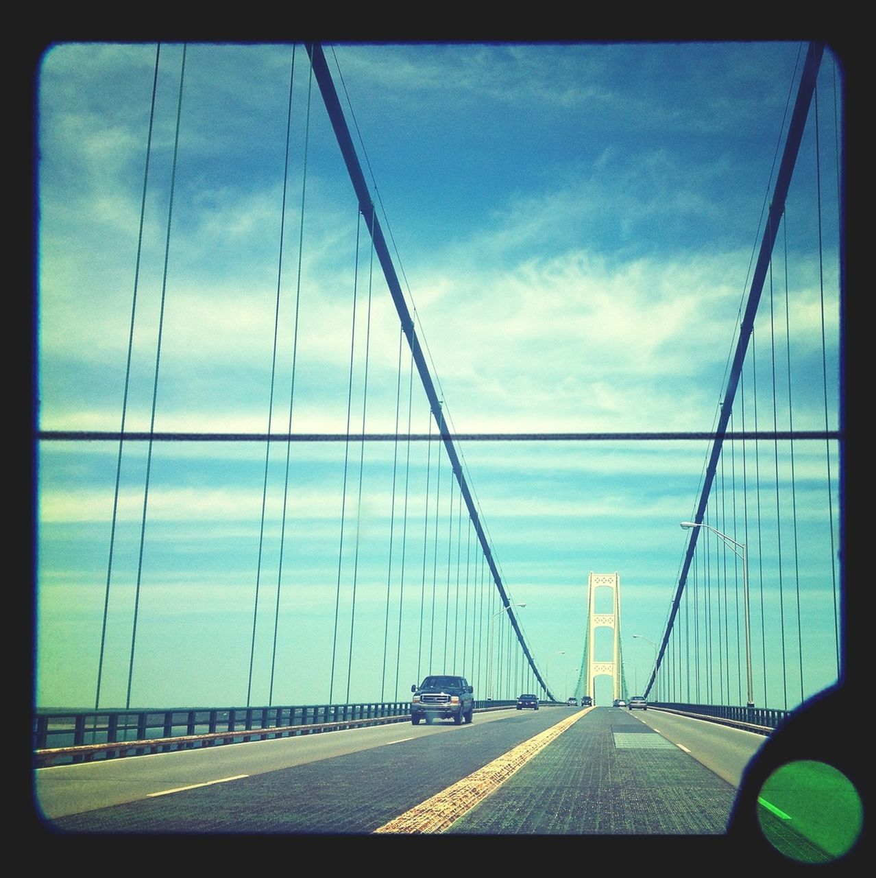 transportation, sky, car, connection, mode of transport, land vehicle, bridge - man made structure, road, cloud - sky, the way forward, engineering, built structure, cloud, diminishing perspective, road marking, highway, architecture, cloudy, travel, suspension bridge