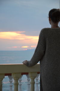 Rear view of woman looking at sea against sky