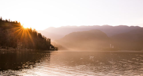 Scenic view of lake against sky during sunset