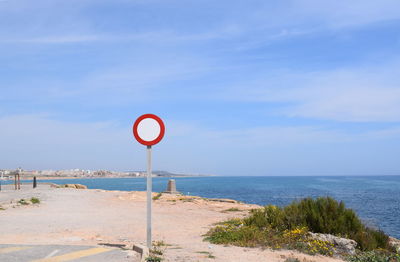 Road sign by sea 