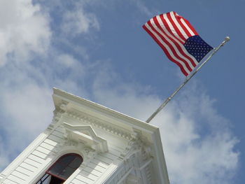Tilted view of american flag on white building