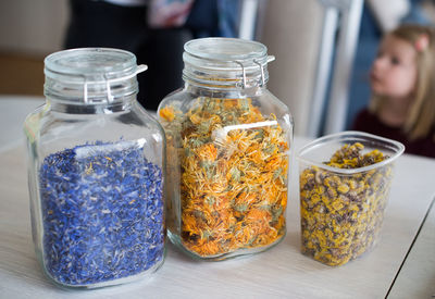 Dry flowers in jars on table