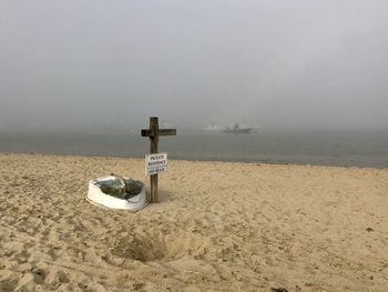 Lifeguard hut on beach against sky