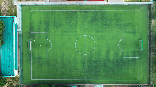 Green soccer field against wall