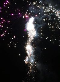 Low angle view of firework display at night