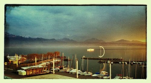 Boats in harbor at sunset