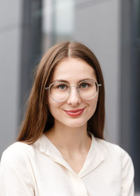 Young woman in business clothes near her office