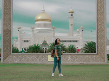 Full length of woman standing outside building