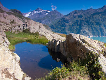 High angle view of pond against mountains in winter